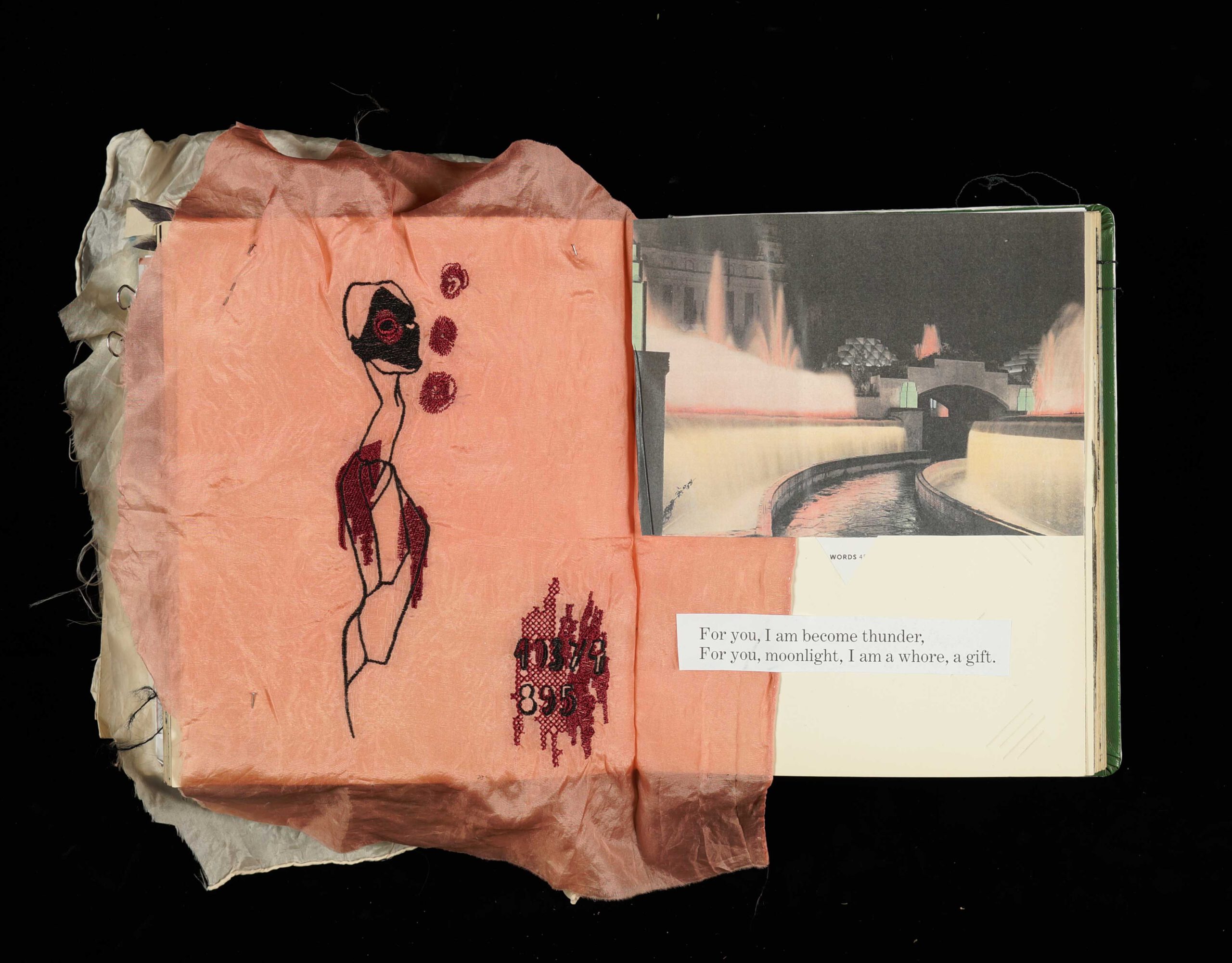 Machine embroidery of female figure in a sketchbook on pink silk