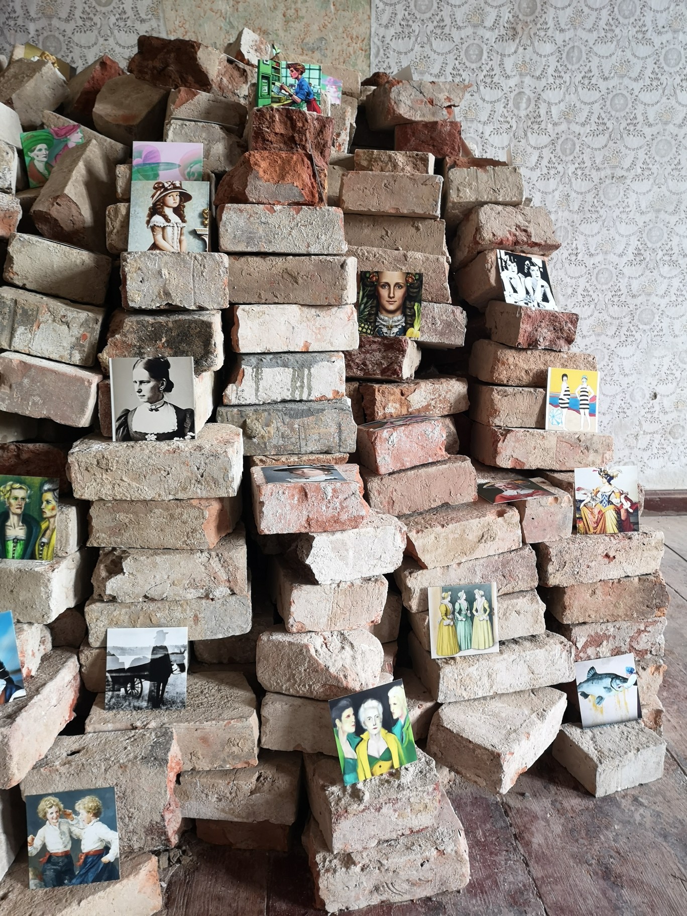 Stack of old brick stones with images in exhibition.