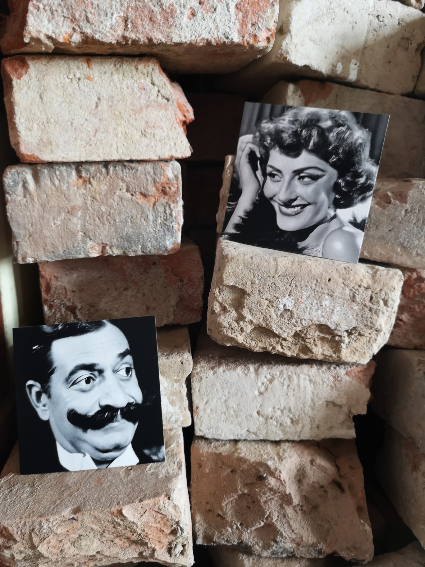 Ai created bw photograph of fictious elegant woman and man in old movie style.